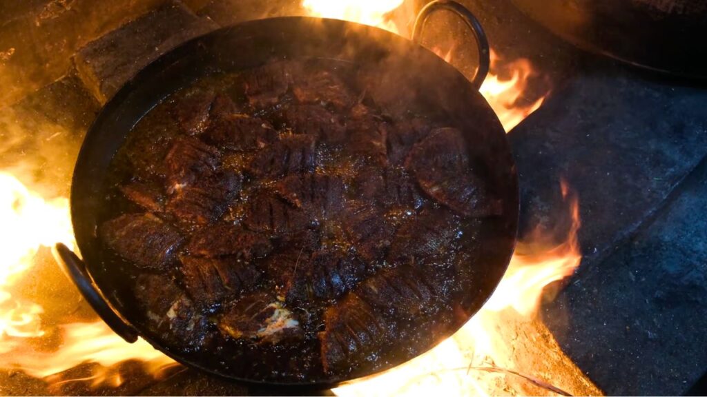 Making of fish fry in firewood oven
