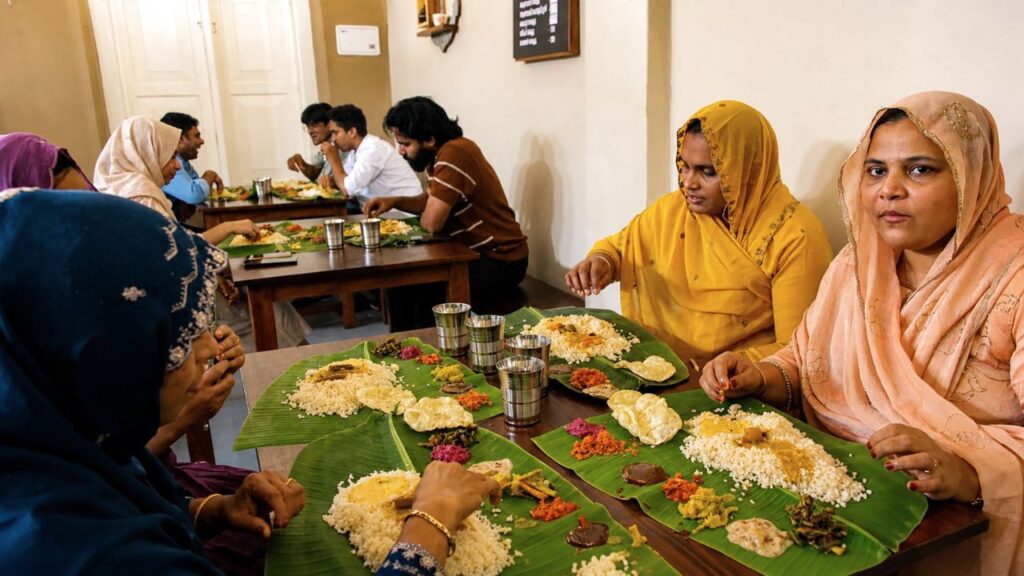 People enjoying food at Meenolam Seafood Restaurant in Calicut Beach